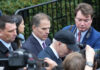 Hunter Biden Sparks Media Storm with Bold Defiance Group of men in suits walking through a crowd