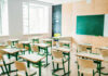 Empty classroom with desks and a chalkboard