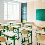 Empty classroom with desks and a chalkboard