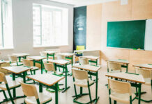 Education Chief’s Payday Sparks Revolt Empty classroom with desks and a chalkboard