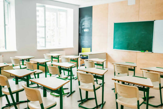 Empty classroom with desks and a chalkboard