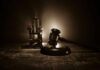 Shocking Turn: 60 Lawmakers Challenge Death Row Conviction Gavel and electric chair in dimly lit room