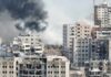 Ceasefire Ends, Chaos Unleashed on Kyiv A view of destroyed buildings with smoke rising in the background