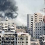 Ceasefire Ends, Chaos Unleashed on Kyiv A view of destroyed buildings with smoke rising in the background