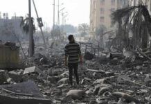 New Allegations Emerge From Gaza Detentions Person walking through rubblestrewn street in daylight
