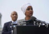 Woman speaking at a podium with microphones