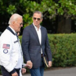 Why Hunter’s Pardon Still Sparks Debate Two men walking outside near green bushes
