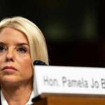 Cancer Fight EXPOSED: Pam Bondi’s Hidden Struggle Woman sitting behind nameplate at conference or meeting