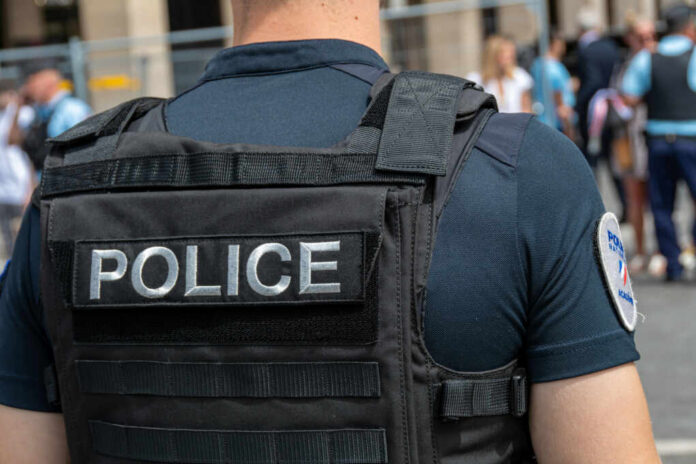 Police officer in uniform with badge on the arm