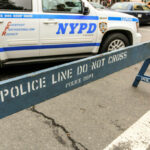 Child Choked in Brooklyn Heist—Suspect Still Loose! NYPD police barricade on city street with vehicles