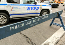 Child Choked in Brooklyn Heist—Suspect Still Loose! NYPD police barricade on city street with vehicles
