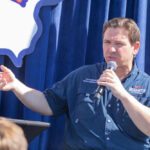 Florida’s Shocking Surrogacy Crackdown Person speaking into microphone during public event