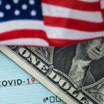 Millions Could Reclaim IRS Penalties — Act Fast! A dollar bill partially covered by an American flag and a COVID-19 stimulus check