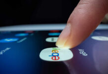 eBay Rejects GameStop’s $56B Offer—Too Risky! A finger tapping the eBay app icon on a smartphone screen