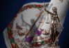 Bronze statue of Lady Justice in front of the Virginia state flag