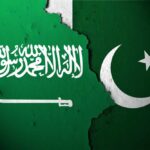 Flags of Saudi Arabia and Pakistan split by a torn seam
