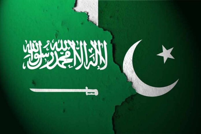 Flags of Saudi Arabia and Pakistan split by a torn seam