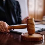 Utah Judge RESIGNS — Relationship Texts EXPOSED A judge's hand holding a gavel in a courtroom setting