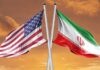 Flags of the United States and Iran crossed against a sunset background