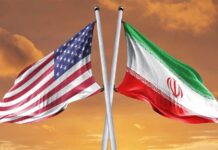 Flags of the United States and Iran crossed against a sunset background