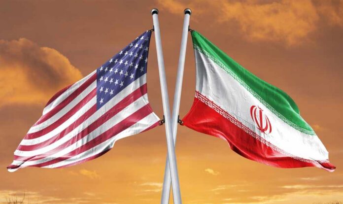 Flags of the United States and Iran crossed against a sunset background