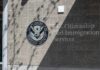 New Green Card Rules Cause Chaos for Thousands Signage for U.S. Citizenship and Immigration Services on a building