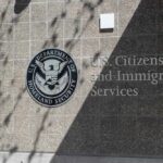 New Green Card Rules Cause Chaos for Thousands Signage for U.S. Citizenship and Immigration Services on a building