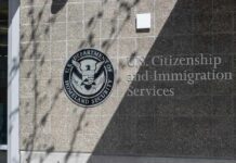 New Green Card Rules Cause Chaos for Thousands Signage for U.S. Citizenship and Immigration Services on a building