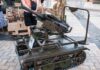 A tracked military artillery piece displayed at an exhibition
