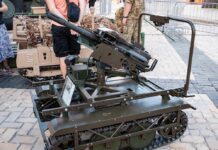 A tracked military artillery piece displayed at an exhibition