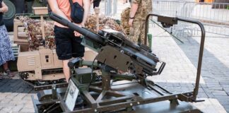 A tracked military artillery piece displayed at an exhibition
