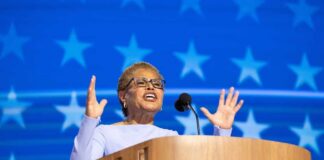 A female speaker passionately addressing an audience from a podium