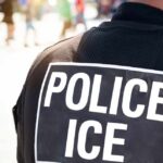 Outrageous Proposal: Jail ICE to Save California? Close-up of a police officer's back with a 'POLICE ICE' badge