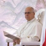 Pope’s STUNNING Admission—Did Vatican Legitimize Slavery? Pope seated in a ceremonial chair with flags in the background
