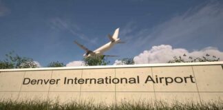 Sign for Denver International Airport with an airplane flying overhead