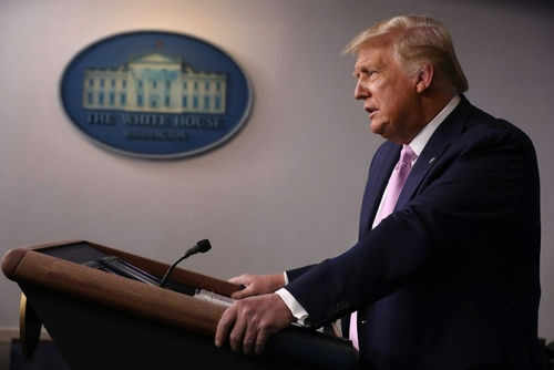 trump-press-briefing2566328753 Person speaking at a podium with White House emblem