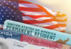 Constitution Rewrite: Naturalized Americans OUT? U.S. flag with visa and permanent resident card in foreground