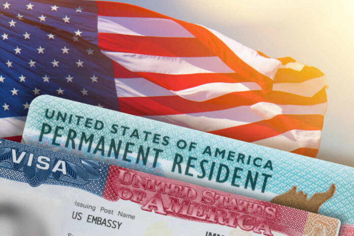 U.S. flag with visa and permanent resident card in foreground