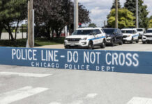 Daylight Inferno In Grant Park Police line barrier with parked police cars behind.