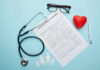 Health claim form with stethoscope and eyeglasses displayed