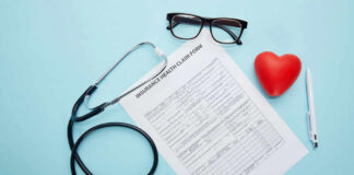 Health claim form with stethoscope and eyeglasses displayed