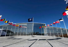 NATO’s Nuclear Tease Rattles Moscow NATO headquarters with member flags in front under a clear blue sky