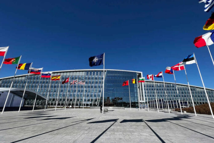 natoid2284120437jpg NATO headquarters with member flags in front under a clear blue sky