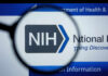 magnifying glass over NIH logo on a website