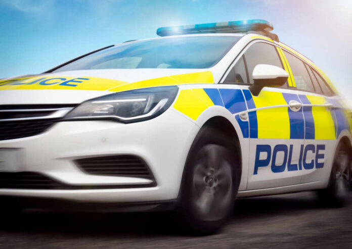 police-car2488631091jpg Police car driving with flashing lights visible