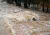 Weak Storm, Massive Flooding Threat Flooded river with muddy, turbulent water