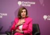Pelosi’s Endorsement Upends Moderates A woman in a pink suit speaking at a conference