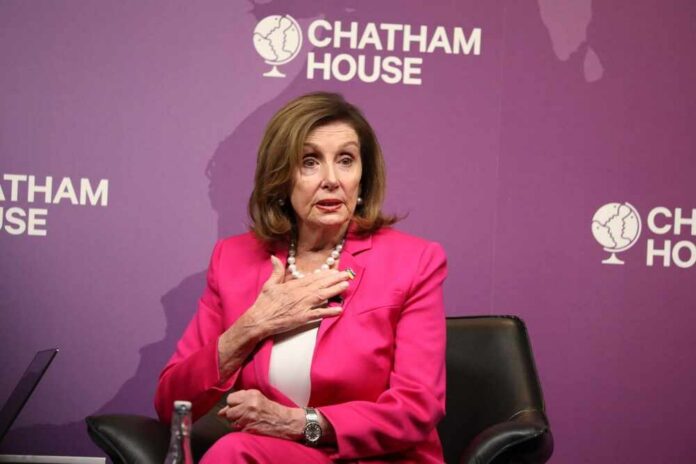A woman in a pink suit speaking at a conference