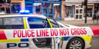 Police car with a 'Do Not Cross' tape in front