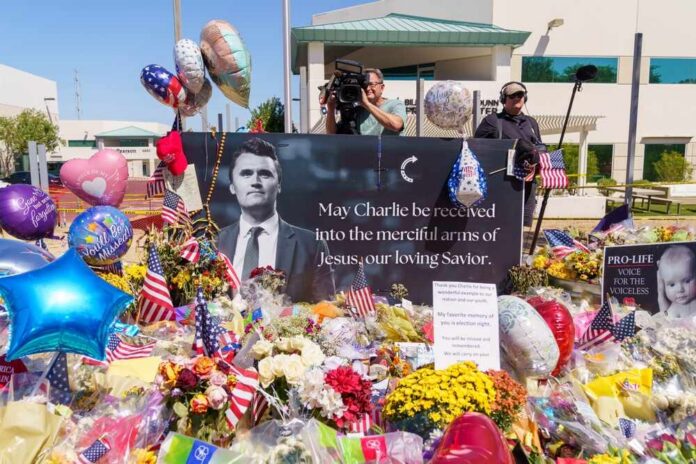 Memorial with flowers, balloons, flags, and a large tribute poster